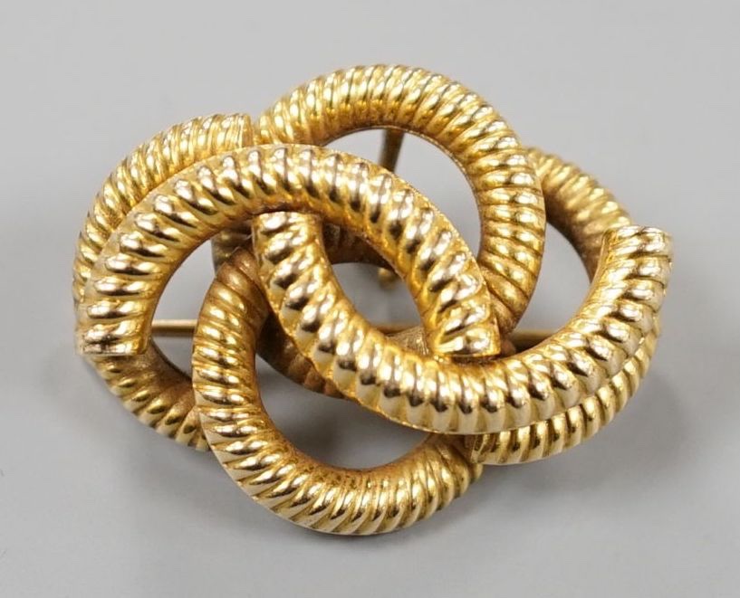 A late Victorian textured interwoven hollow yellow metal brooch, 32mm, gross 7.7 grams.